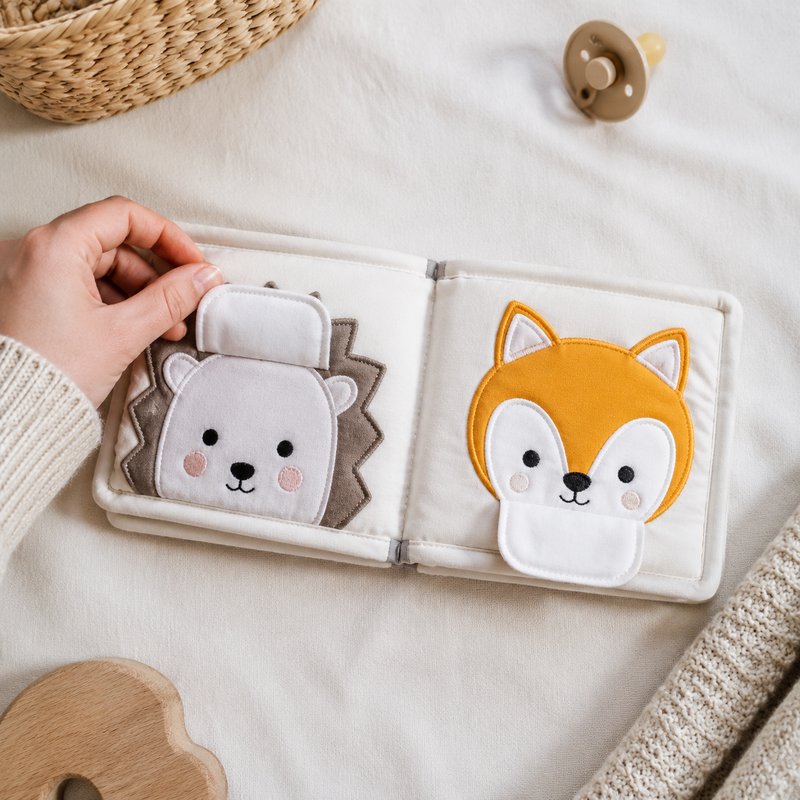Peekaboo Animal Faces Cloth Book size comparison with baby hands
