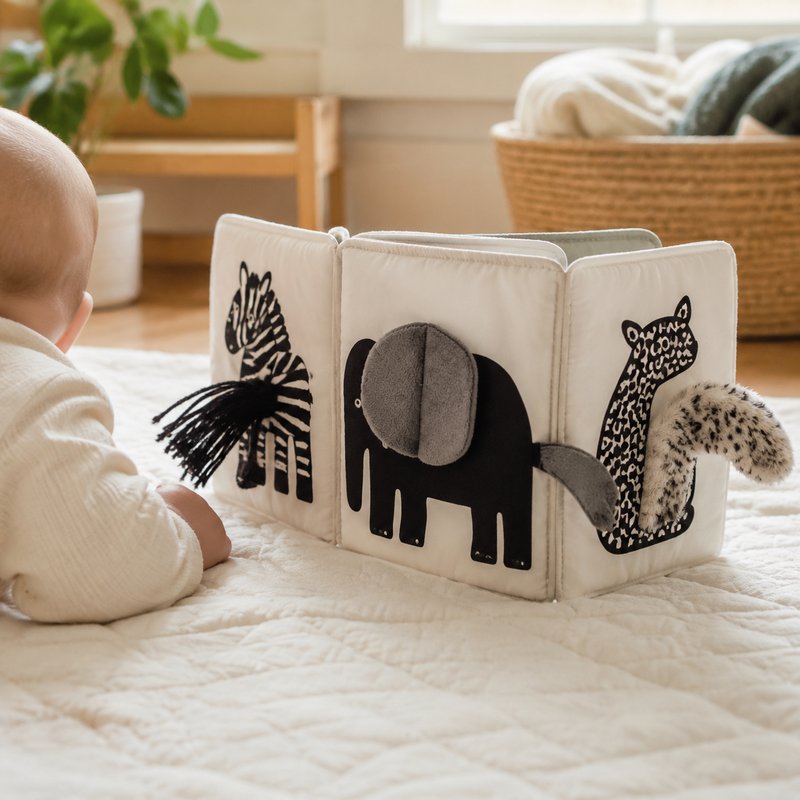 Oversized Sensory Tails Cloth Book in use — baby playing with cloth book