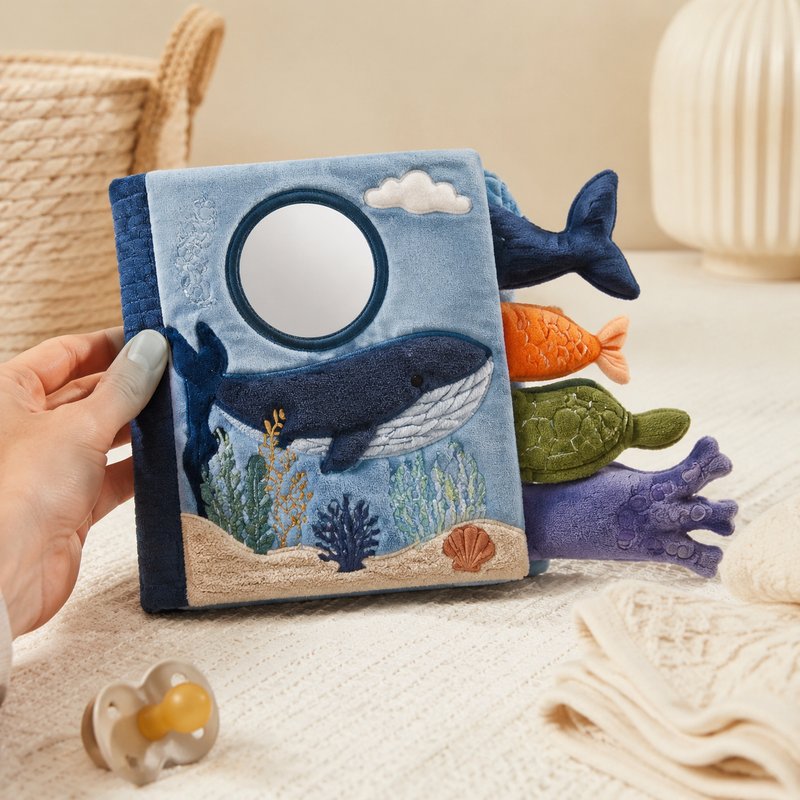 Ocean Tails Touch & Mirror Cloth Book size comparison with baby hands