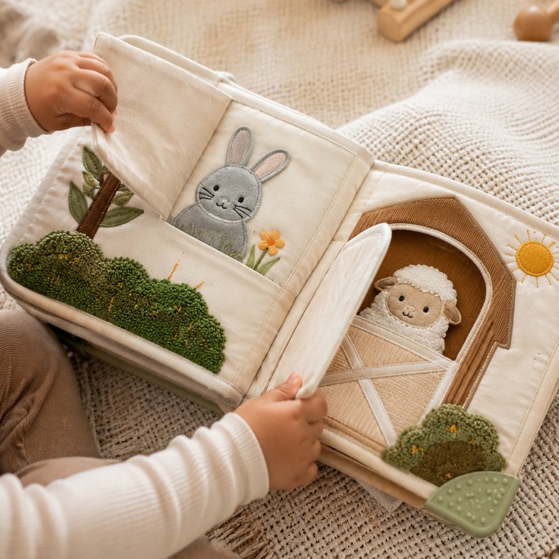 Lift-the-Flap Discovery Cloth Book in use — baby playing with cloth book