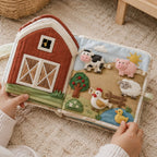 Full Tethered Farm Quiet Book in use — baby playing with cloth book