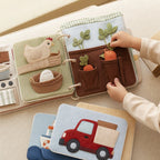 Modular Expandable Quiet Book System in use — baby playing with cloth book